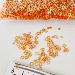 Aplicações em lantejoula estrelas laranja